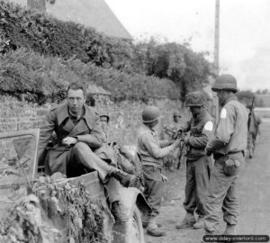 Derrière un prisonnier allemand installé à bord d’une Kübelwagen, des soldats appartenant à la 2ème division blindée américaine neutralisent un pistolet mitrailleur MP 40 à Notre-Dame-de-Cenilly. Photo : US National Archives