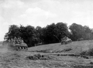 7 août 1944 : un escadron de chars Sherman transportant des unités d’infanterie progresser dans le secteur de Reffuveille. Photo : US National Archives