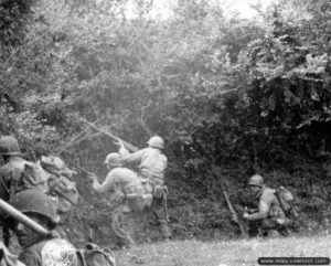 5 juillet 1944 : des soldats de la 90th (US) Infantry Division, 358th Infantry Regiment, ouvrent le feu à courte distance dans le secteur de Saint-Jores. Au centre de la photo, un Américain utilise un lance-grenades M7 au bout de son fusil M1 Garand. Photo : US National Archives