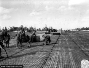 Le 18 juin 1944, le 819th EAB pose du grillage à maille carrée SMT sur l'ALG A-6. Photo : US National Archives