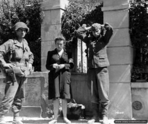 A Saint-Lô, un soldat américain veille sur ses prisonniers allemands : un soldat et une volontaire. Photo : US National Archives
