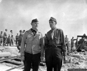 31 juillet 1944 : le Major-General Frank Seymoure Ross (à droite) et le Brigadier General Clarence Lemar Burpee supervisent le déchargement du LST 21 à Tourlaville. Photo : US National Archives