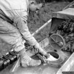 Photos of Port-en-Bessin in 1944 6 Un sapeur fait le plein de carburant de la cuve d’un GMC CCKW 353 utilisé en camion-citerne à Port-en-Bessin. Photo : US National Archives