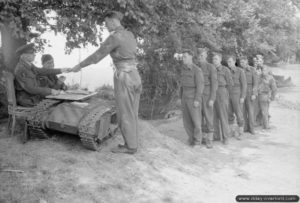 C'est le jour de paye pour les personnels du N° 4 Beach Squadron, RAF. Un Goliath SdKfz 303 est utilisé en guise de table. Photo : IWM