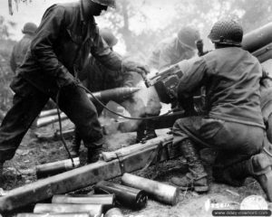 Artilleurs américains de la 4th Infantry Division en action avec leur canon HM3 de 105 mm dans le secteur de Carentan.