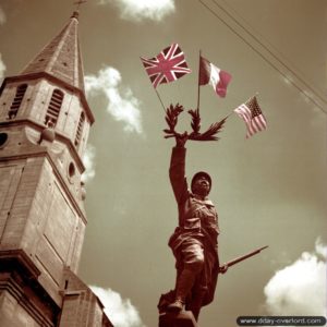 Le monument aux Morts de la Première Guerre mondiale de Creully décoré à l’occasion de la libération du village. Photo : Archives Canada