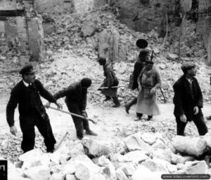La population de Montebourg déblaie les gravats qui encombrent les rues. Photo : US National Archives