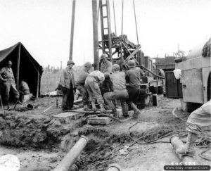 Mise en oeuvre d’une foreuse à hauteur de l’hôpital de campagne de Saint-Hilaire-Petitville. Photo : US National Archives