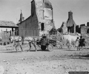 Un attelage au milieu des ruines de la place Gambetta à Isigny-sur-Mer. Photo : US National Archives
