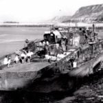 Photos of Port-en-Bessin in 1944 15 L'épave d'une canonnière allemande après les combats à marée basse à Port-en-Bessin. Photo : IWM