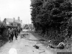 Une patrouille armée par la 35ème division d’infanterie progresse le long de la rue du Chêne Dancel à Saint-Lô. Photo : US National Archives