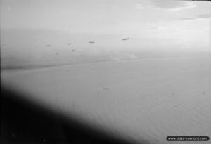 Stirling Mk 4 bombers tow Horsa gliders during Operation Mallard on June 6, 1944 shortly before 9:00 pm. The Sword Beach area is visible in the background. Photo: IWM