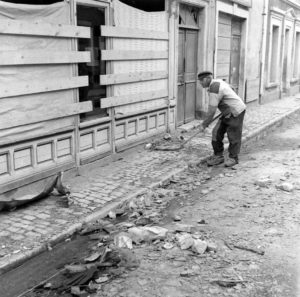 Juin 1944 : un habitant de Grandcamp-les-Bains déblaye les gravas des rues après la libération. Photo : US National Archives