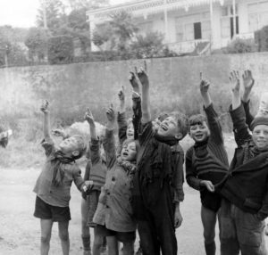 Rue Gambetta à Grandcamp-les-Bains, des enfants semblent désigner du doigt des avions pour le photographe. Photo : US National Archives
