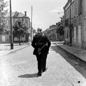 Un pompier français, qui a revêtu son plus bel uniforme à l'occasion de la libération, le long de la rue du château à Carentan. Photo : US National Archives