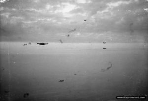 July 18, 1944: Lancaster and Halifax bombers under fire from the German Flak east of Caen (Operation Goodwood). Photo: IWM