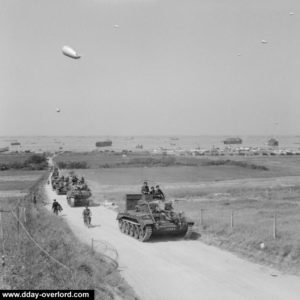 7 juin 1944 : un char Mk V Cromwell du 4th County of London Yeomanry, 22nd Armoured Brigade, 7th Armoured Division, en tête d'une colonne de véhicules blindés (dont un Sherman Firefly en deuxième position) à La Rivière en provenance du secteur King de Gold Beach. Photo : IWM B 5251