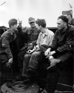 Coast Guard Robert E. O'Connell in discussion with German prisoners evacuated to England. Photo: US National Archives