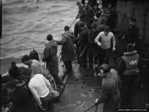 Des rescapés de deux LSI américains coulés lors d'une attaque d'un E-Boat allemand sont récupérés à bord de l'HMS Beagle dans la Manche. Photo : IWM