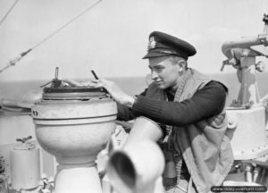 Second Lieutenant Anthony Large, a South African volunteer, takes a compass course aboard HMS Holmes. Photo: IWM