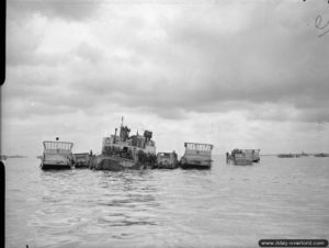 A barge transformed to accommodate a kitchen supplies landing craft LCM Mark 3 and LCVP. Photo: IWM