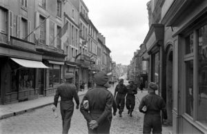 Des militaires britanniques déambulent le long de la rue Saint-Martin à Bayeux durant l'été 1944, après la libération. Photo : LIFE Magazine