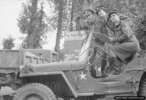 15 août 1944 : un soldat de la police militaire indique la route au caporal Joyce Collings et à la première classe Cecilia Strong dans le secteur de Bayeux. Photo : IWM