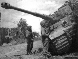 Des soldats anglais de la 49th Division inspectent l’épave du char Tigre « 334 » abandonnée dans Rauray. Photo : IWM